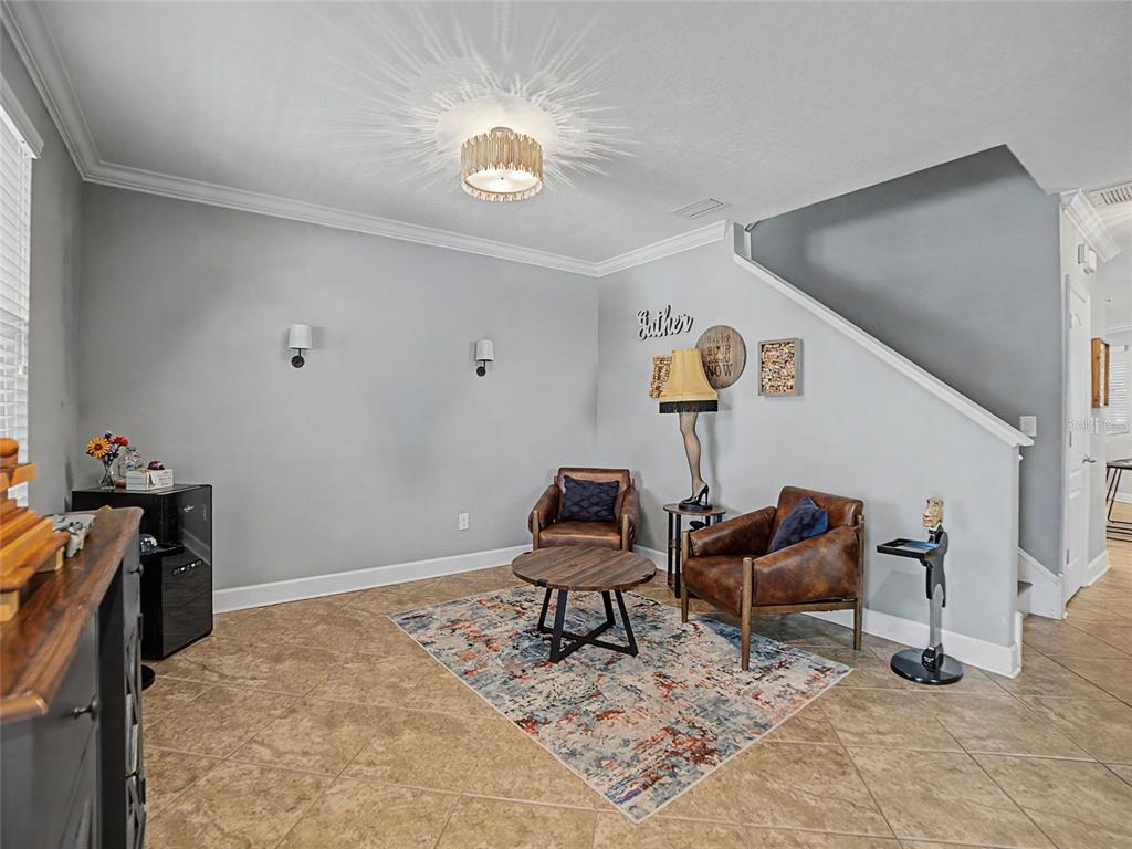 An entryway features a white front door, a mirror, and a home bar area — 16910 DORMAN ROAD, LITHIA, FL