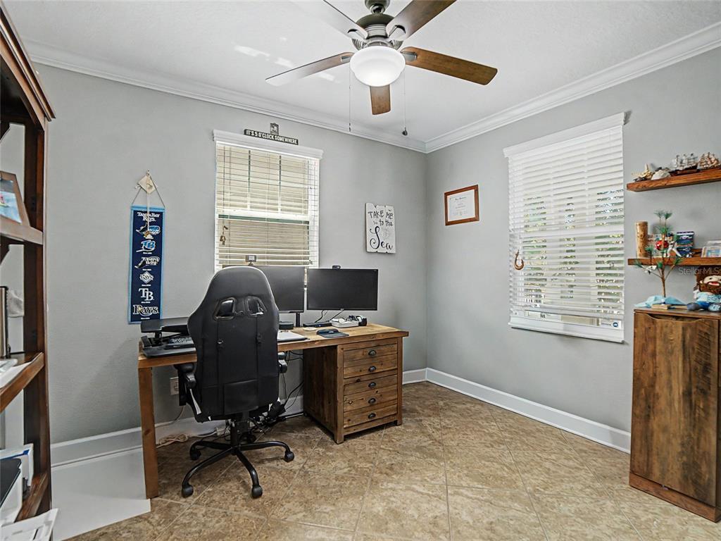 A living area features two leather armchairs, a round coffee table, and a leg lamp — 16910 DORMAN ROAD, LITHIA, FL