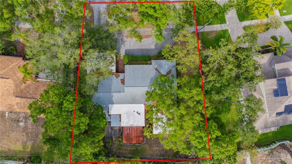 An aerial view shows a house with a gray roof surrounded by trees and landscaping — 504 W DAVIS BOULEVARD, TAMPA, FL