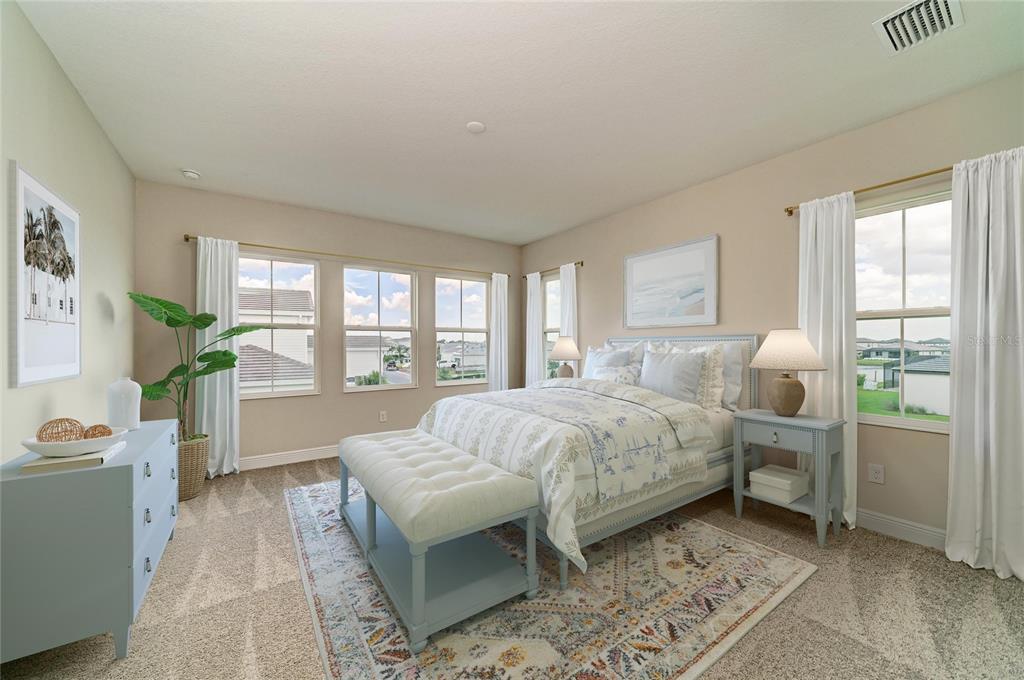 A bedroom features a bed with a patterned quilt, a bench, and light blue furniture — 10245 CROSS RIVER TRAIL, PARRISH, FL