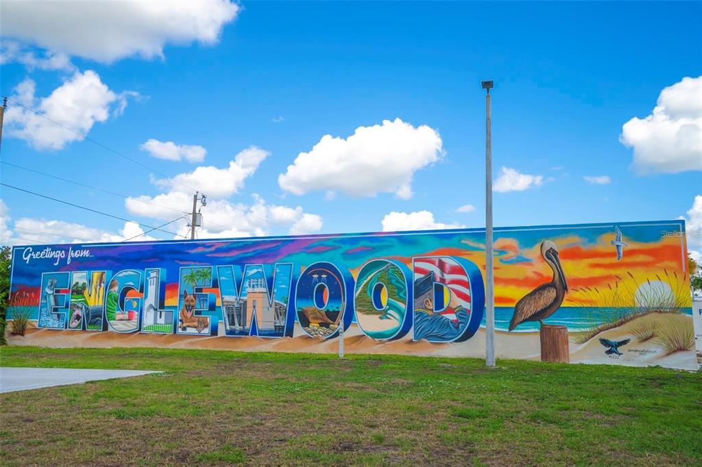 A large, colorful mural reading "Greetings from Englewood" painted on an exterior wall — 10506 PENDLETON AVENUE, ENGLEWOOD, FL