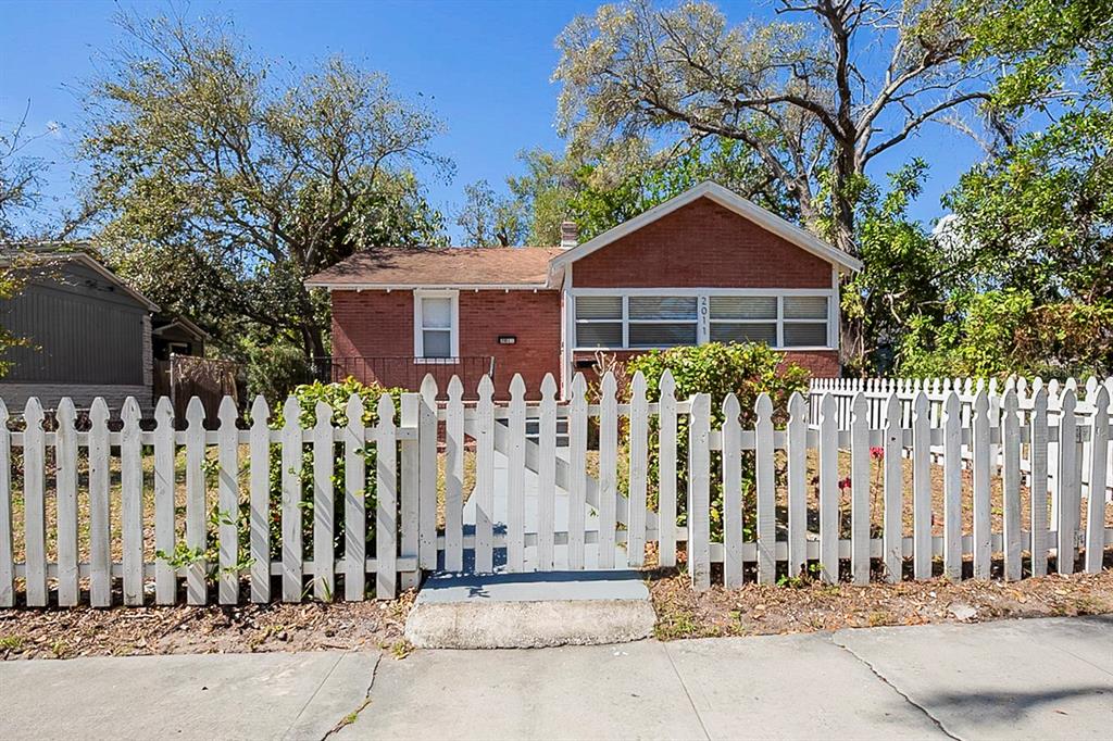 A red brick house with a white picket fence and a front gate — 2011 10TH STREET S, ST PETERSBURG, FL