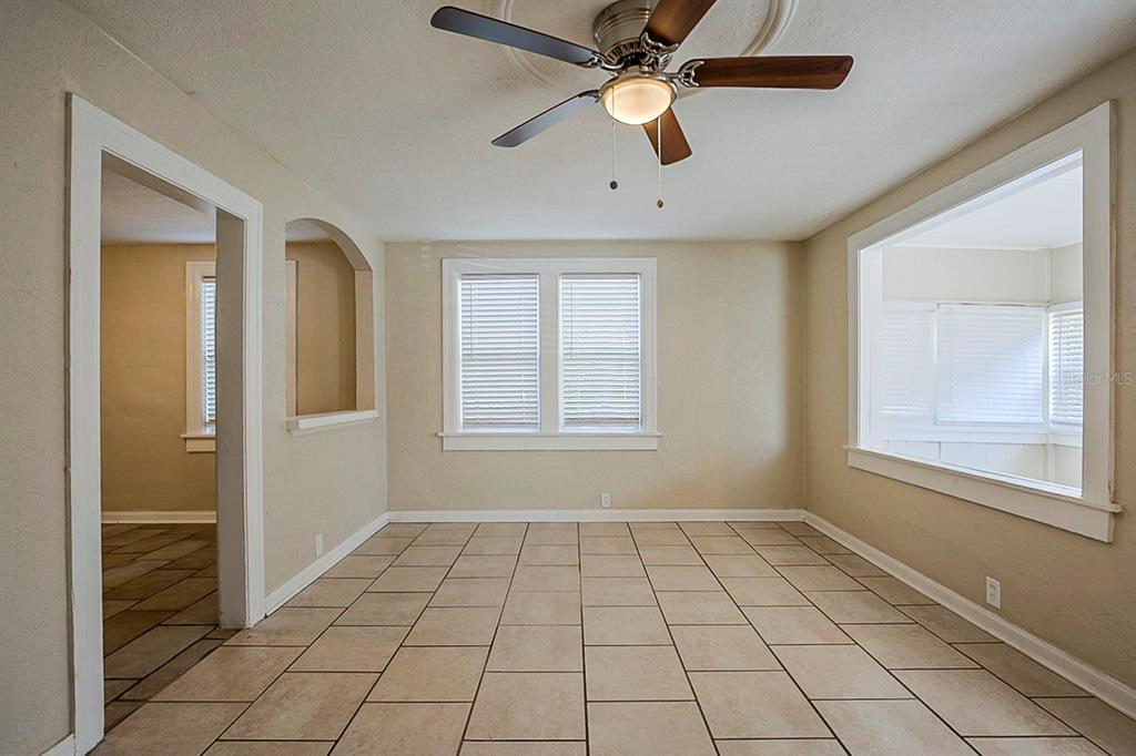 A room with tiled floors, a ceiling fan, and windows looking into an adjacent space — 2011 10TH STREET S, ST PETERSBURG, FL