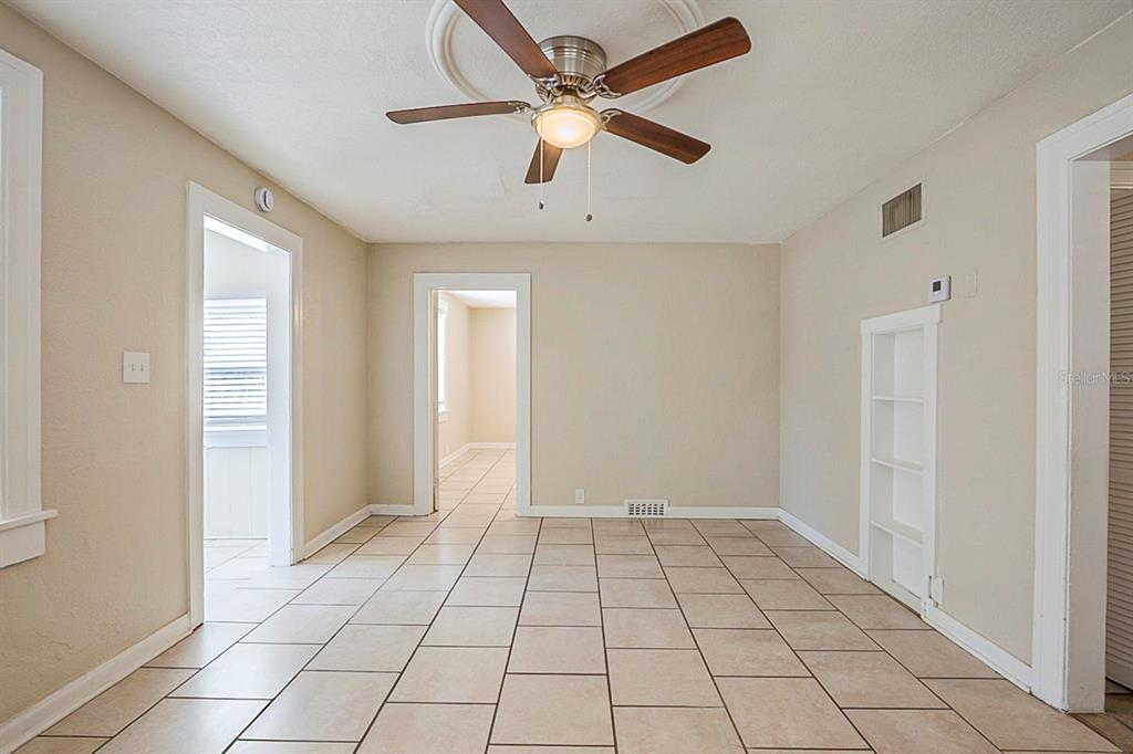 A room with beige walls, tiled floors, a ceiling fan, and two doorways — 2011 10TH STREET S, ST PETERSBURG, FL