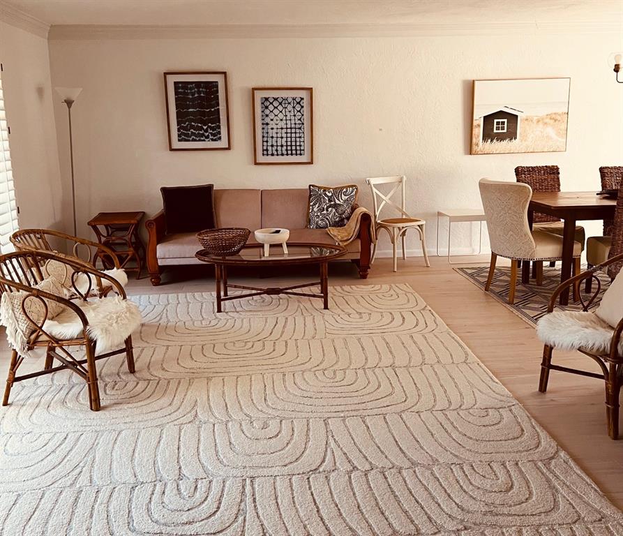 A living and dining area features a textured rug, rattan chairs, and a beige sofa — 2908 CAPTIVA DRIVE, SARASOTA, FL