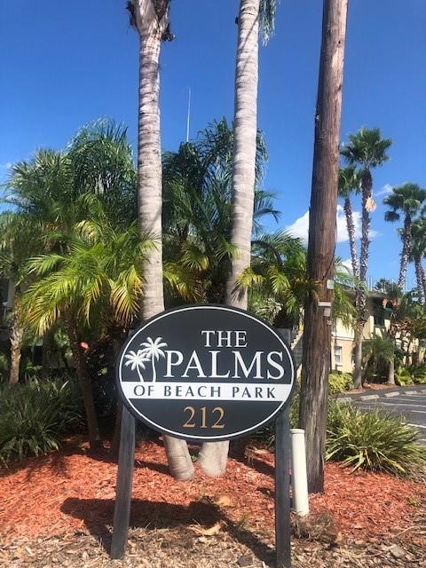 A sign for The Palms of Beach Park stands in front of palm trees and landscaping — 212 S CHURCH AVENUE UNIT 107, TAMPA, FL