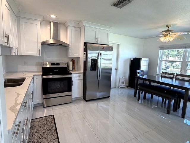 A single-story house with light siding, stone accents, and a two-car garage — 1629 WILLOW RUN, SEBRING, FL