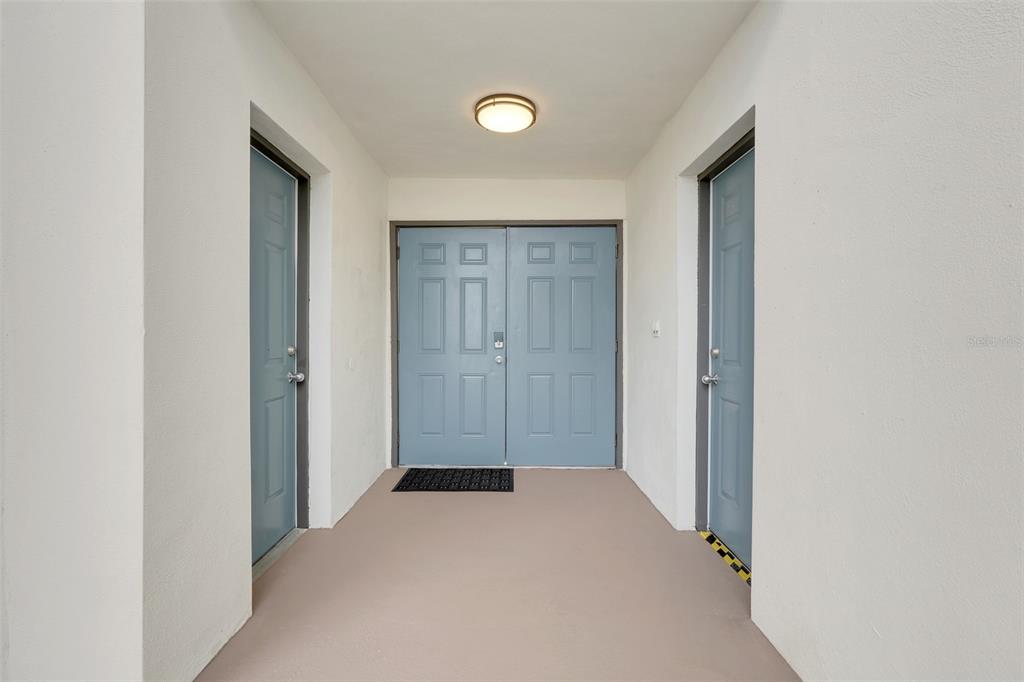 A covered entryway features a double front door flanked by two single doors — 8807 CRAYSON COURT, KISSIMMEE, FL