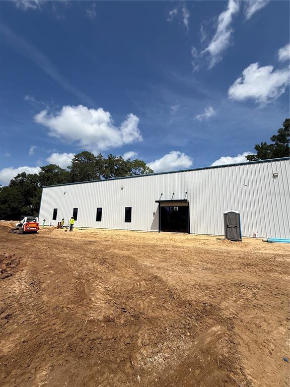 An expansive, unfinished industrial warehouse space features a concrete floor and exposed steel framing — 12142 SE COUNTY 484 HIGHWAY, BELLEVIEW, FL