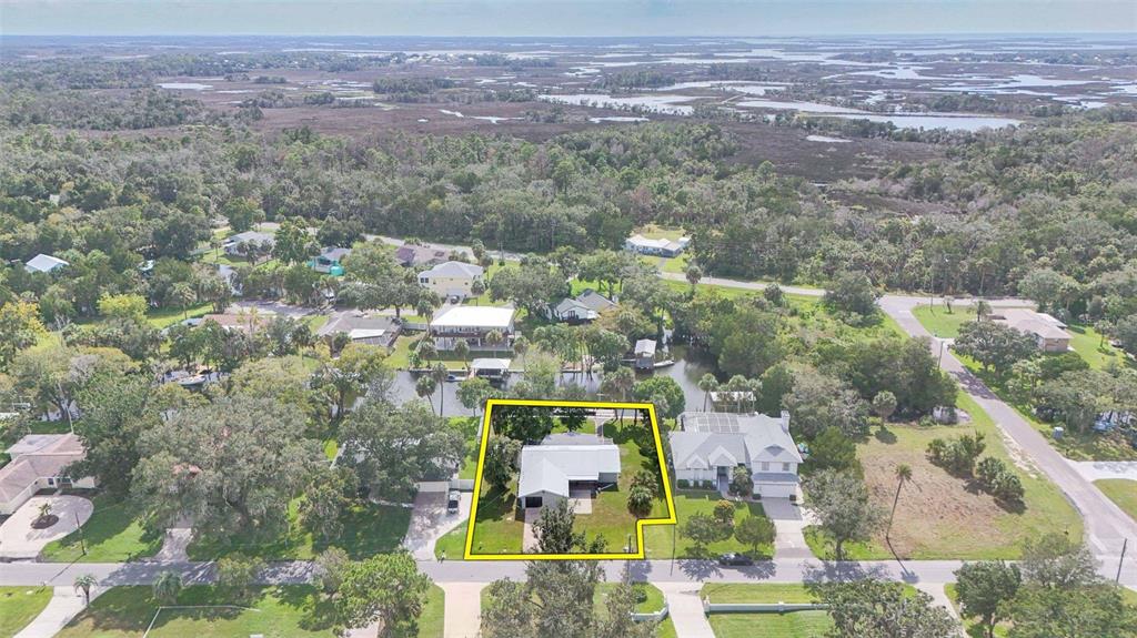 An aerial view shows a single-story house with a yellow outline on a residential lot — 2236 N WATERSEDGE DRIVE, CRYSTAL RIVER, FL
