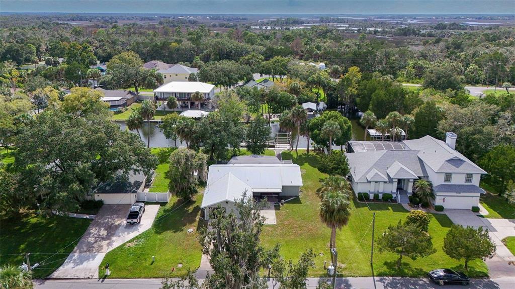 An aerial view of several houses with yards and a canal in a wooded neighborhood — 2236 N WATERSEDGE DRIVE, CRYSTAL RIVER, FL