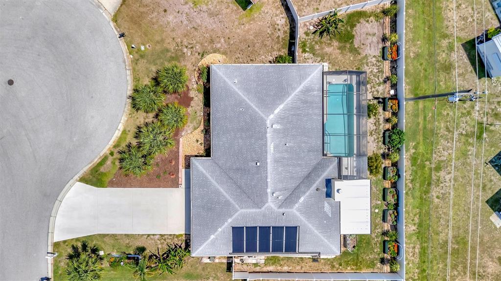 An aerial view shows a house with a pool, solar panels, and a concrete driveway — 5729 AUGUSTA CIRCLE, SARASOTA, FL