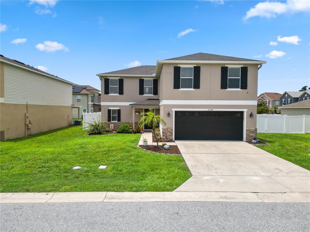An aerial view shows a residential house with a fenced backyard and surrounding neighborhood streets — 4188 FESTIVAL POINTE BOULEVARD, MULBERRY, FL