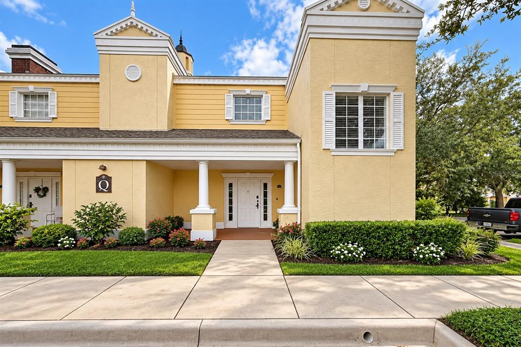 A kitchen features dark brown cabinets, granite countertops, stainless steel appliances, and light wood flooring — 7510 SEVEN EAGLES WAY, REUNION, FL