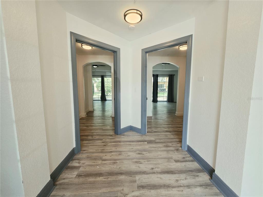 A living room with a tray ceiling, ceiling fan, and an adjacent dining area — 7510 SEVEN EAGLES WAY, REUNION, FL