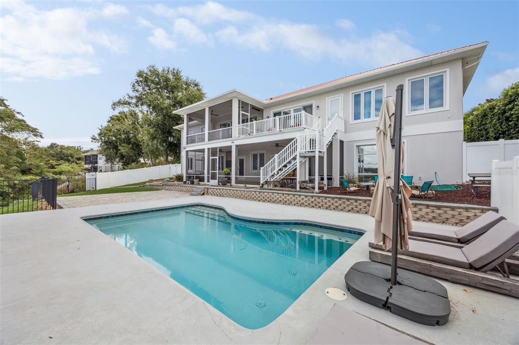 A two-story house with a screened balcony, outdoor staircase, and a swimming pool in the backyard — 16909 FLORENCE VIEW DRIVE, MONTVERDE, FL
