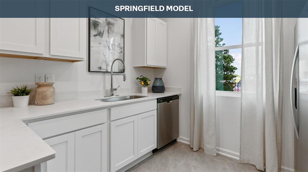 A kitchen features white cabinets, a stainless steel dishwasher, a sink, and a window — 277 AYAMONTE ROAD, ST AUGUSTINE, FL