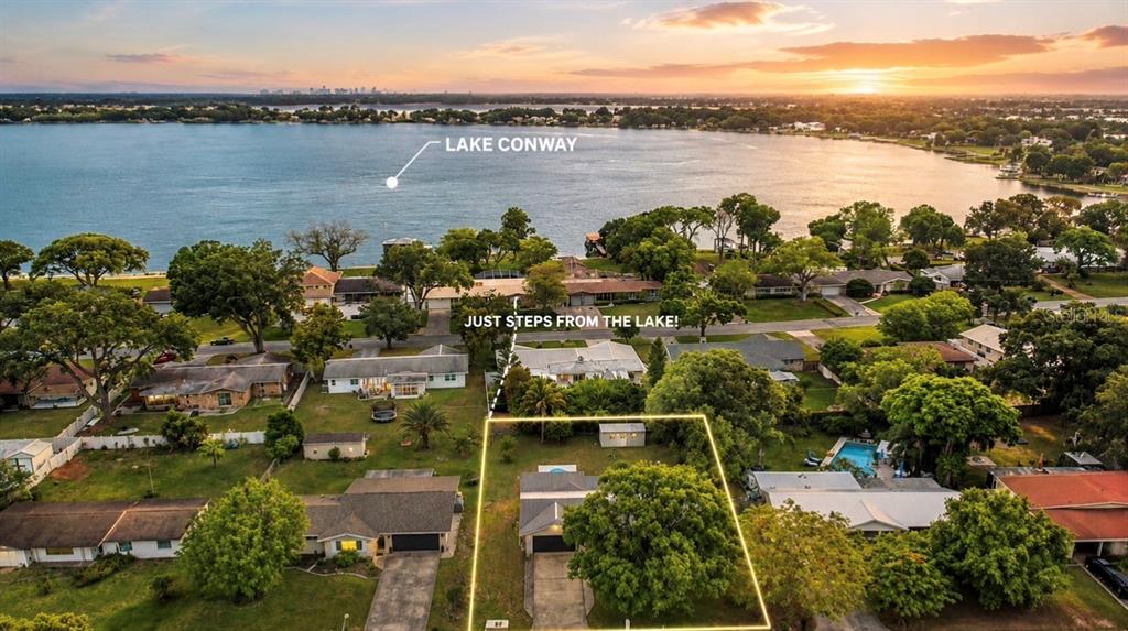 An aerial view shows a residential house with a large tree in the front yard — 3101 FLOWERTREE ROAD, BELLE ISLE, FL