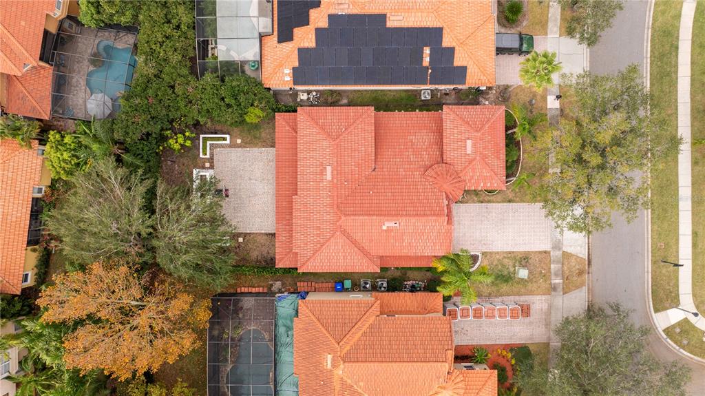 An aerial view shows a residential house with a red tile roof and a driveway — 11410 RAPALLO LANE, WINDERMERE, FL