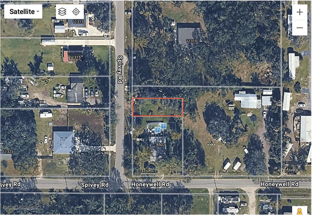 This is a satellite map view showing a rectangular parcel of land outlined in red — SPIVEY ROAD, GIBSONTON, FL