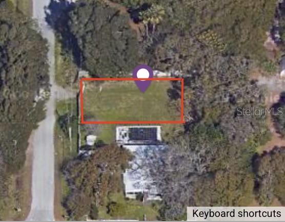An aerial view shows a rectangular vacant lot outlined in red next to a house — SPIVEY ROAD, GIBSONTON, FL