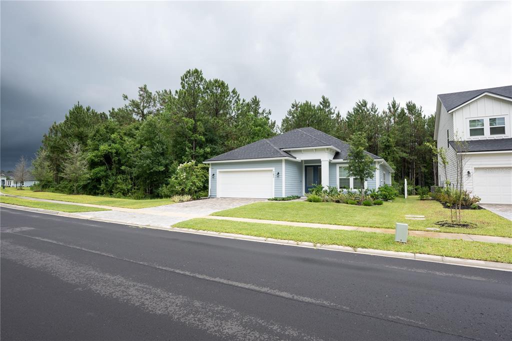 A light blue single-story house with a white garage and a paved driveway — 782 SILVER LANDING DRIVE, ST AUGUSTINE, FL
