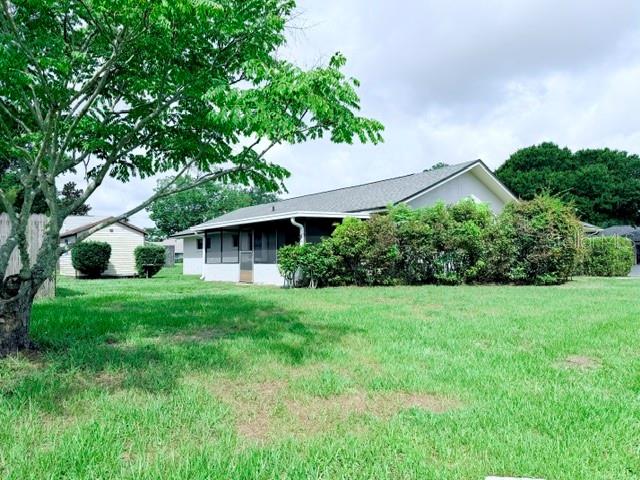 A single-story house with a screened-in porch sits behind a large tree and lawn — 298 QUAIL COURT, CASSELBERRY, FL