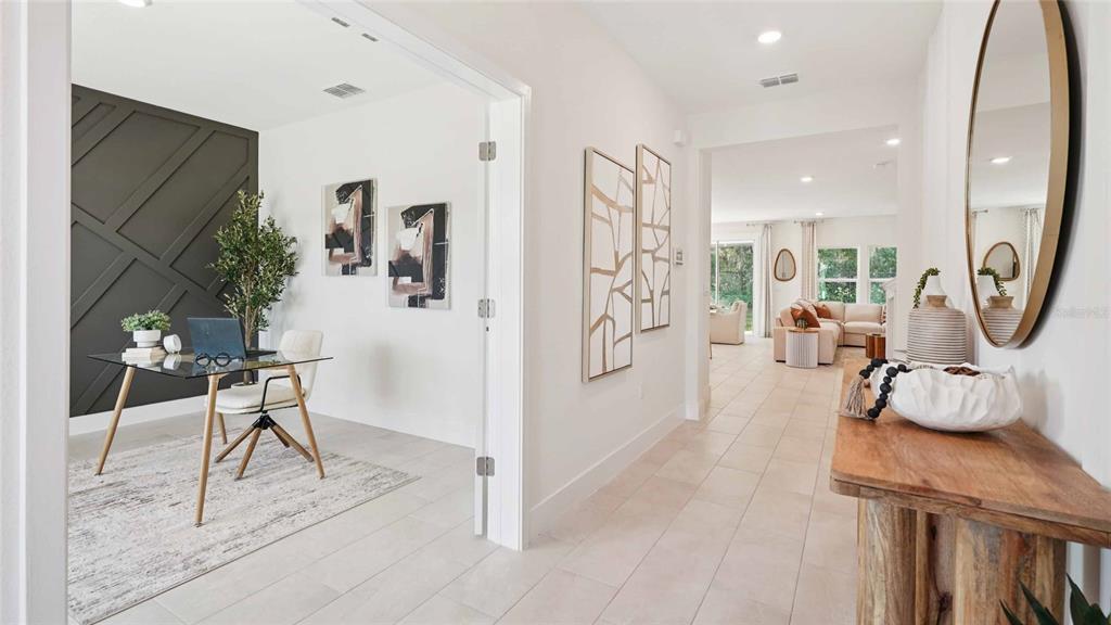 A home office with a dark accent wall sits beside a hallway leading to a living area — 11207 DUCKLING WAY, WEEKI WACHEE, FL