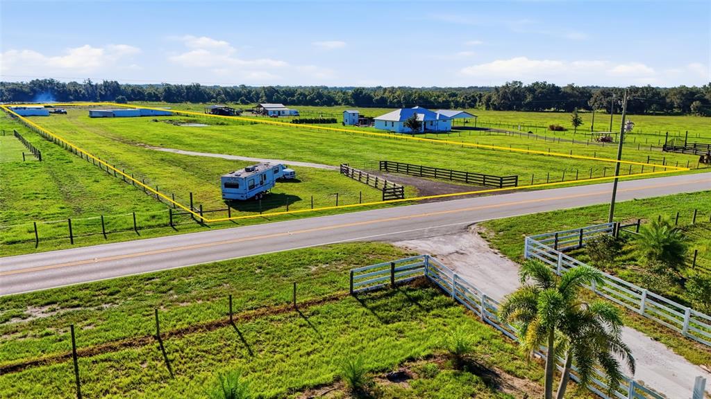 An aerial view shows a rural property with a house, outbuildings, and a parked RV — 3130 SE AIRPORT ROAD, ARCADIA, FL