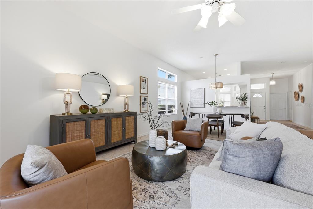 A living room features a gray sofa, two brown leather chairs, and a metal coffee table — 272 SEA WOODS DRIVE N, ST AUGUSTINE, FL