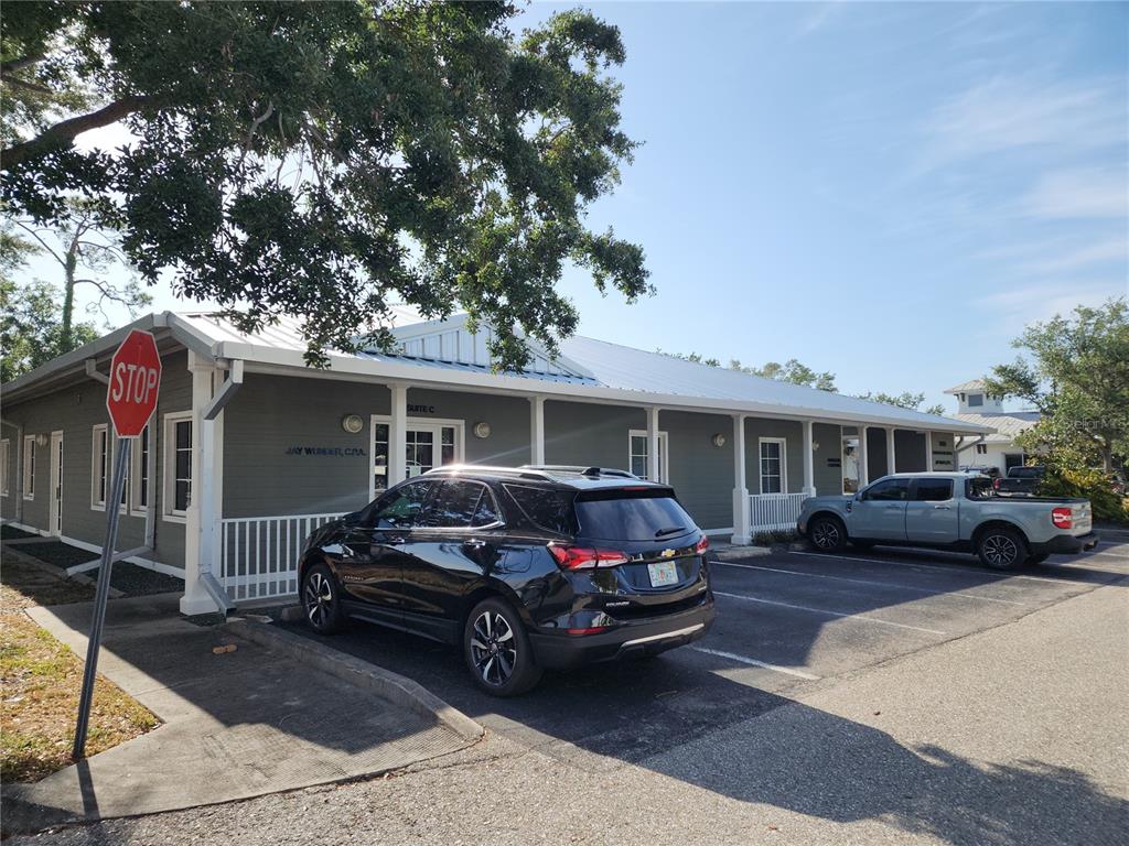 A single-story commercial building with a metal roof and a parking lot in front — 17801 MURDOCK CIRCLE UNIT A, PORT CHARLOTTE, FL