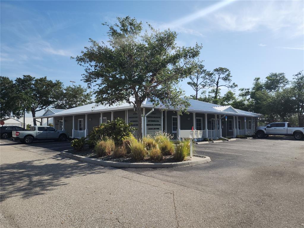 A single-story commercial building with a metal roof and a parking lot in front — 17801 MURDOCK CIRCLE UNIT A, PORT CHARLOTTE, FL