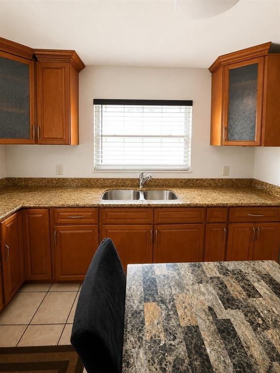 A cluttered garage features a concrete floor, storage shelving, a refrigerator, and various tools — 1740 S RIO GRANDE AVENUE, ORLANDO, FL