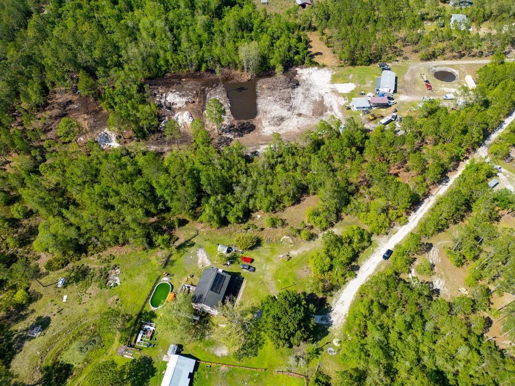 An aerial view shows a wooded lot outlined in red next to a residential property — 3770 BALSAM COURT, ORMOND BEACH, FL