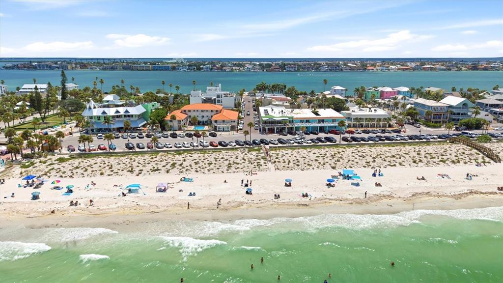 An aerial view of a beach with a parking lot and buildings in the background — 113 3RD AVENUE, ST PETE BEACH, FL