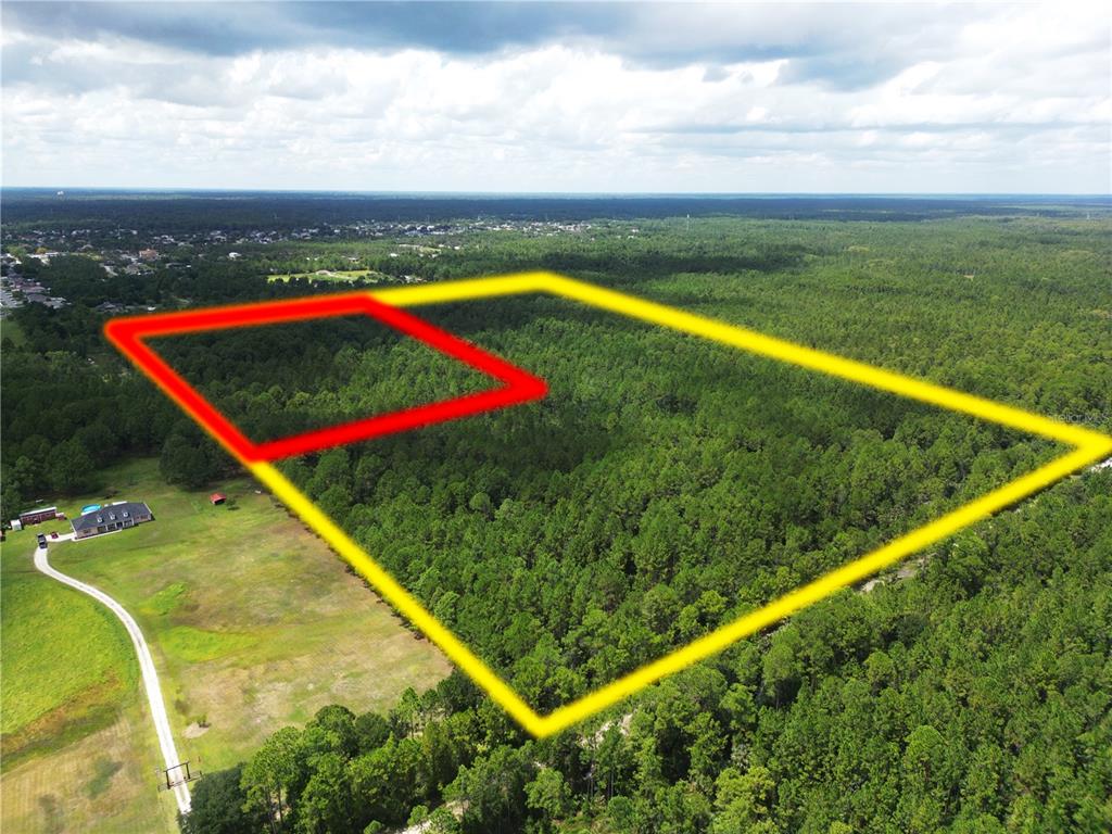 An aerial view shows a large, wooded plot of land outlined in yellow and red — CADEHILL DRIVE, DELTONA, FL