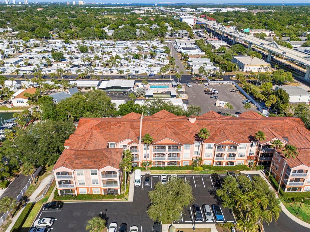 An aerial view shows a waterfront residential complex with a swimming pool and boat slips — 5000 CULBREATH KEY WAY UNIT 1-107, TAMPA, FL
