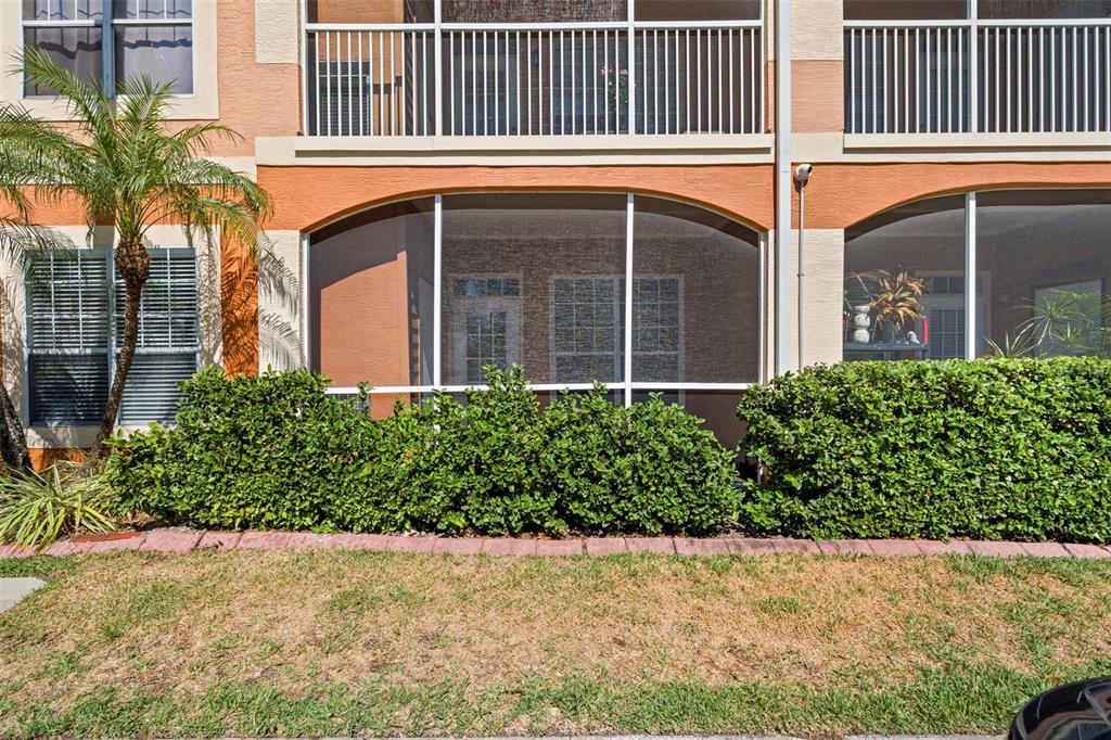 An aerial view shows waterfront apartment buildings with a private marina and boat slips — 5000 CULBREATH KEY WAY UNIT 1-107, TAMPA, FL