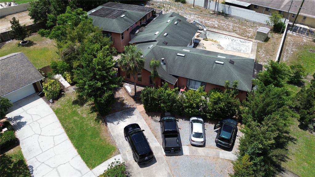 An aerial view shows a house with a green roof, a pool, and four parked cars — 300 BROADVIEW AVENUE, ALTAMONTE SPRINGS, FL