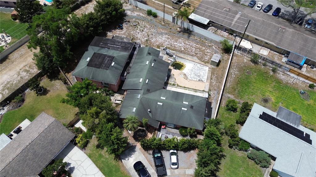 An aerial view shows a residential house with a green roof, pool, and driveway — 300 BROADVIEW AVENUE, ALTAMONTE SPRINGS, FL