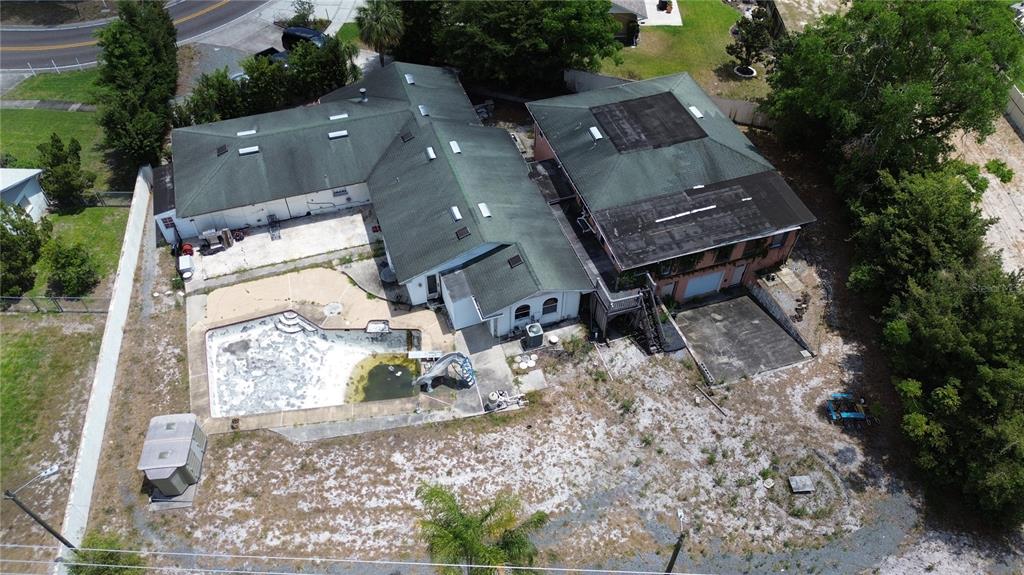An aerial view shows a house with a green roof, a pool, and a garage — 300 BROADVIEW AVENUE, ALTAMONTE SPRINGS, FL