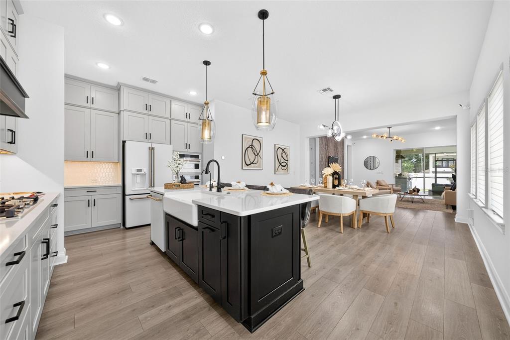 A kitchen with light gray cabinets, a black island, and an open-concept dining area — 1619 S OSCEOLA AVENUE, ORLANDO, FL