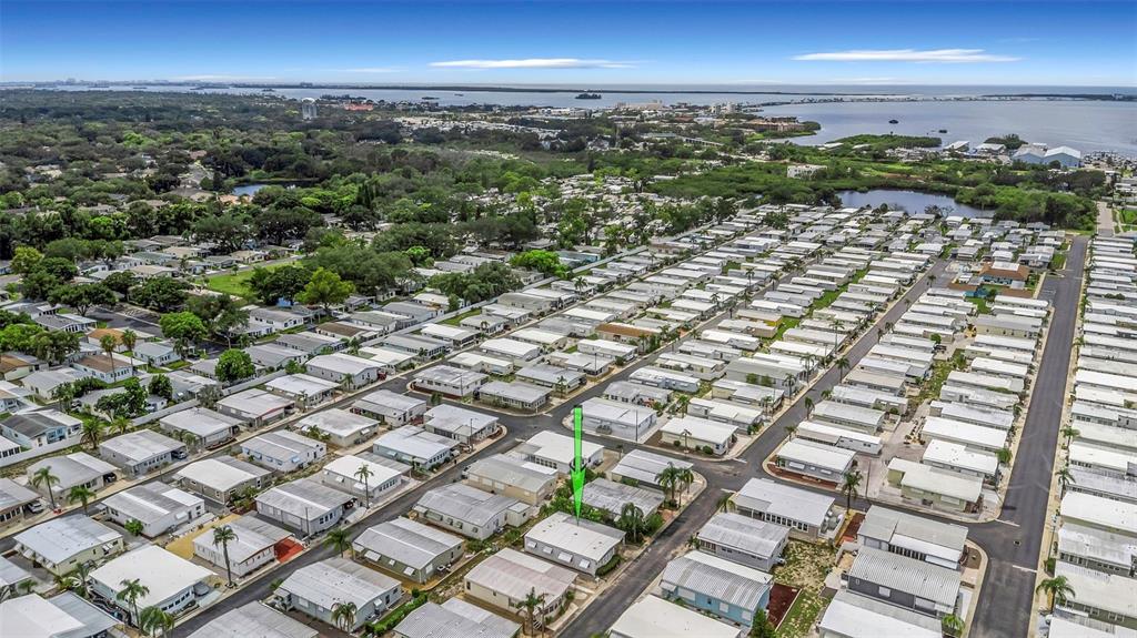 An aerial view shows a manufactured home community with a green arrow pointing to a house — 3301 US ALT 19 N UNIT 253, DUNEDIN, FL