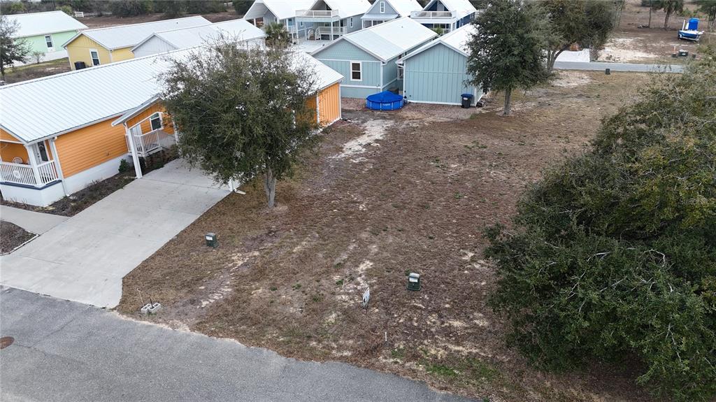 An aerial view shows a vacant lot situated between two houses in a residential neighborhood — TBD SW 879TH STREET, STEINHATCHEE, FL