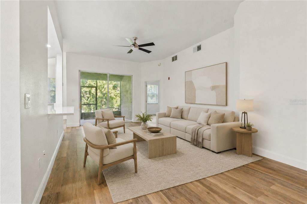 A walkway leads between two beige exterior doors toward a two-story building with green bushes — 9416 MYRTLE CREEK LANE UNIT 701, ORLANDO, FL