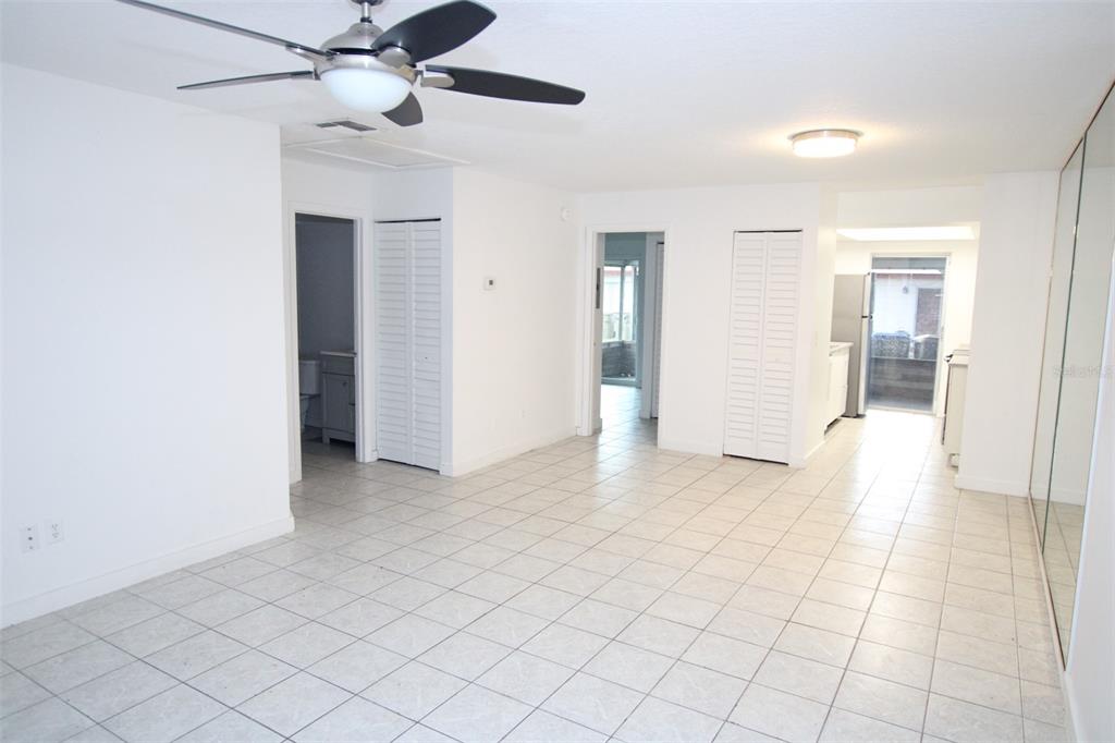 A single-story building exterior features a red door, red shutters, and designated guest parking spaces — 53 W MARBRISA WAY, KISSIMMEE, FL