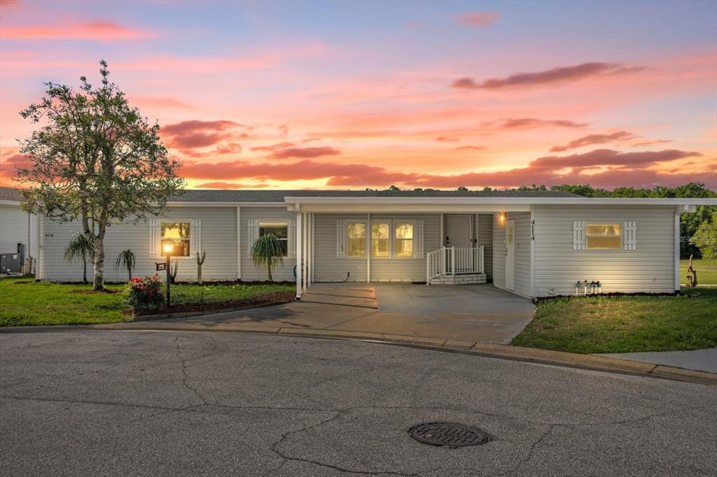 An aerial view shows a single-story house with a carport and a large grassy yard — 4114 MYRTLE OAK COURT UNIT 852, ZELLWOOD, FL