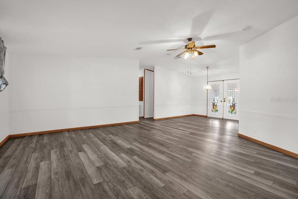 A single-story house with light gray siding features a front carport and a paved driveway — 4114 MYRTLE OAK COURT UNIT 852, ZELLWOOD, FL