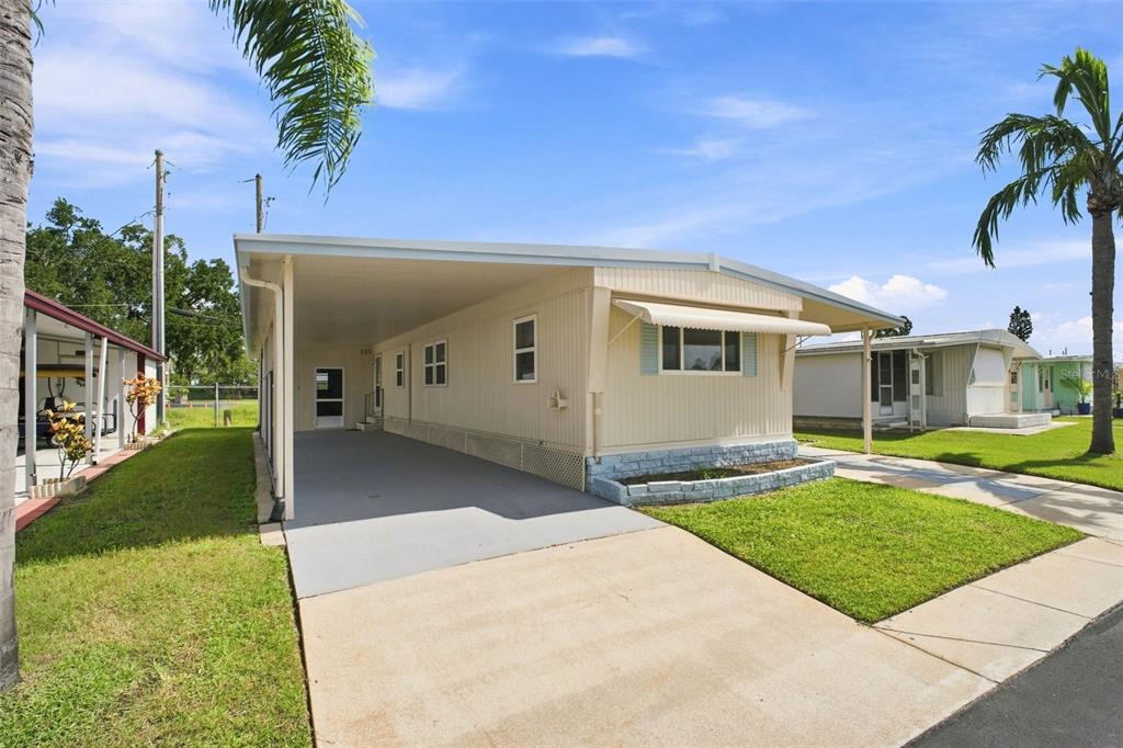 A kitchen with white cabinets, stainless steel appliances, and light wood-look flooring — 6711 CLEMENS BOULEVARD, PORT RICHEY, FL