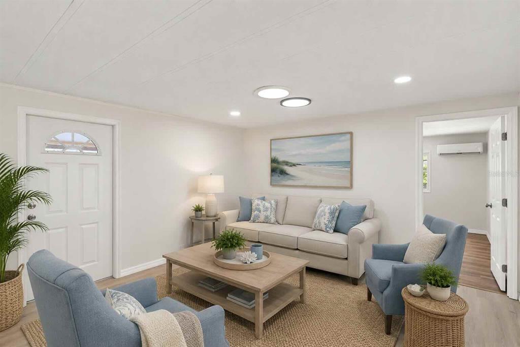 A kitchen with white cabinets, stainless steel appliances, and light wood-look flooring — 6711 CLEMENS BOULEVARD, PORT RICHEY, FL